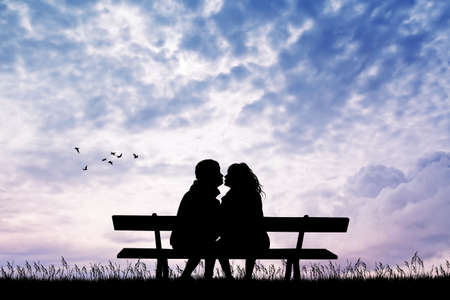 man and girl kissing on bench at sunsetの写真素材