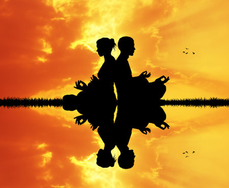 couple doing yoga at sunset