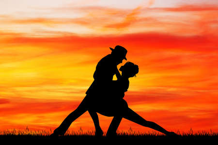 couple dancing tango at sunsetの写真素材