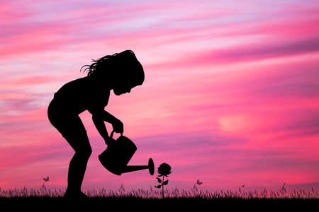 little girl with watering can bath the roseの写真素材