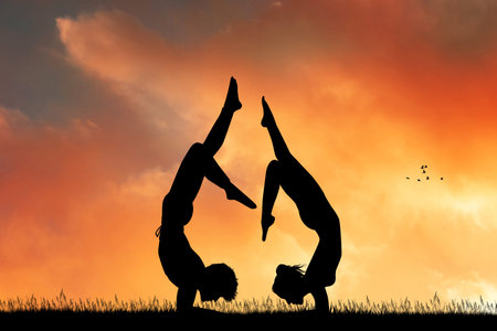 couple yoga together at sunset