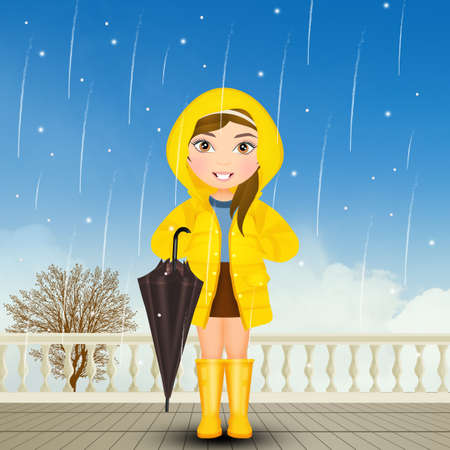 baby girl with raincoat and rain bootsの写真素材