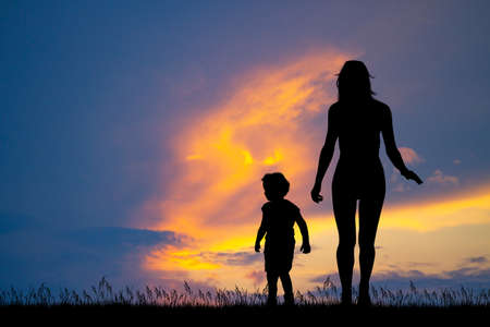 mom with her son at sunsetの写真素材