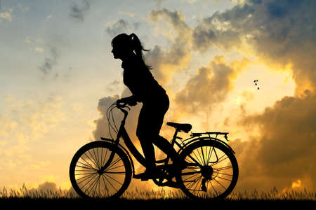 illustration of girl cycling at sunsetの写真素材