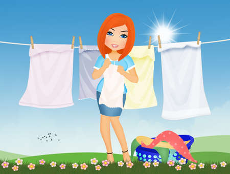 woman hangs clothes in the sunの写真素材