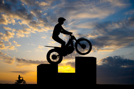 trial motocross silhouette at sunsetの写真素材