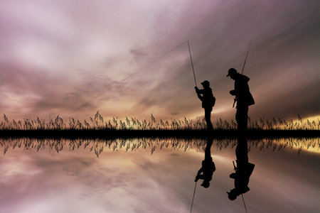 child fishing with his dadの写真素材