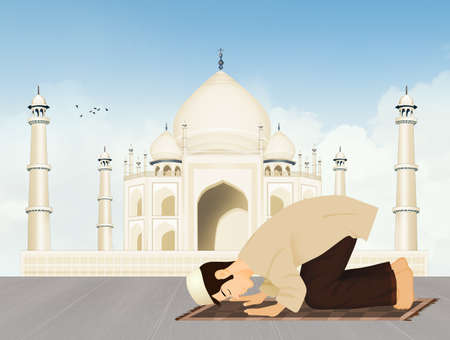 Islamic man prays in front of the Taj Mahalの写真素材