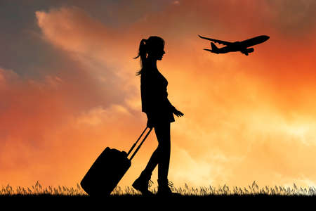 girl with trolley leaves for a journeyの写真素材