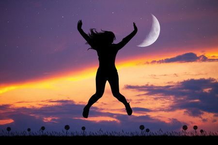 happy girl jumping at sunset