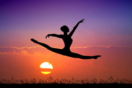 girl does the splits at sunsetの写真素材
