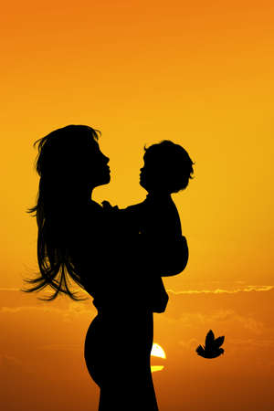 silhouette of woman with babyの写真素材