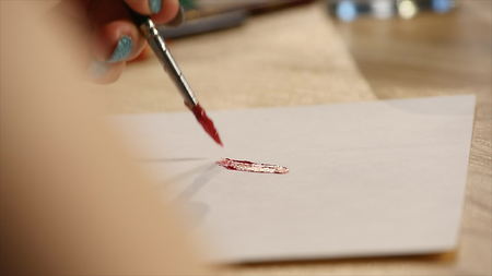 Artist painting with paintbrush in hand.の写真素材