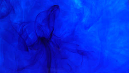 ink in water. Colour ink reacting in water creating abstract cloud formations.の写真素材