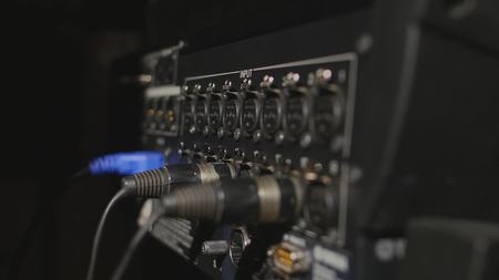 Inserting professional XLR audio cables to the rear panel of the professional recorder.の写真素材