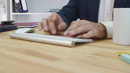 A pleased businessman sittingin his office working at his computer.の写真素材