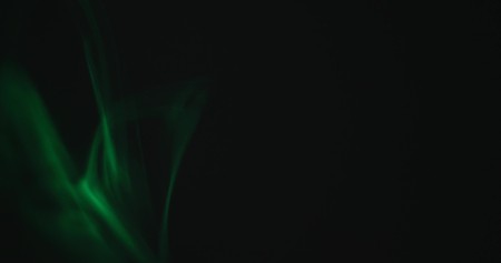 Green smoke on a black background.の写真素材