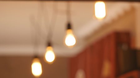 Group of vintage bulb lights with lens flare 3d rendering animation. Lights is turned on.の写真素材