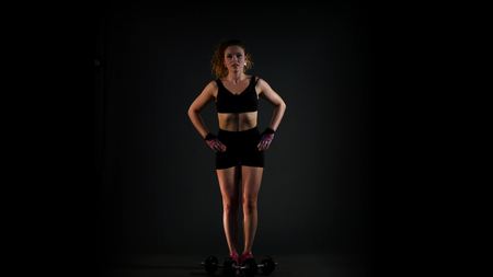 beautiful strong woman exercises with dumbbells.の写真素材