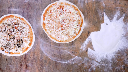 Cook s hands in the kitchen putting the ingredients on the pizza. Pizza concept. Production and...