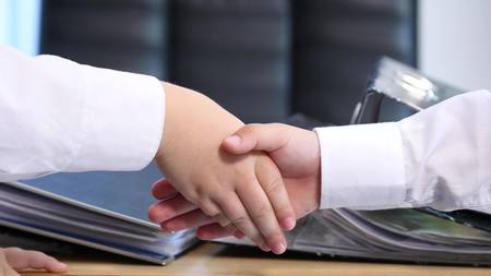 Handshake between a two childrenの写真素材