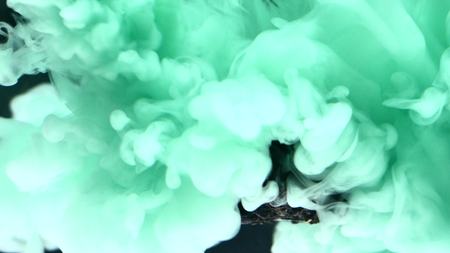 abstract flowing ink in water with stone.の写真素材