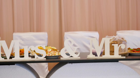 Mr. and Mrs. block letters on a table reserved for the bride and groom.の写真素材