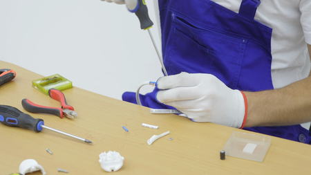 Using screwdriver for take apart of electrical plug.の写真素材