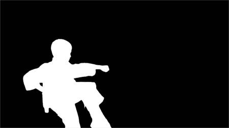 Young karate makes rack on a black background, Silhouette.の写真素材