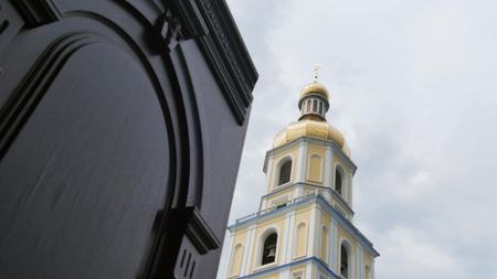 White with yellow Walls of Church Golden Cupolas, Crosses. Blue Sky on a Background.の写真素材