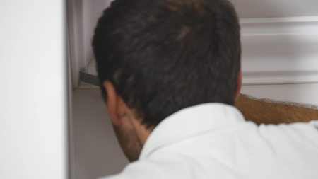 Worker fixes the plinth to the ceiling. close up.の写真素材