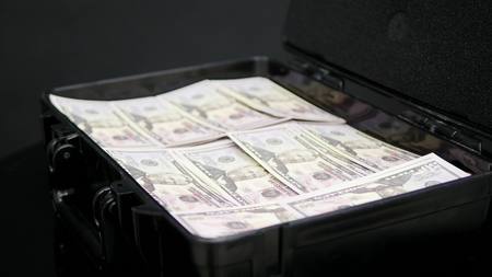 Close up rotation of case full of one million dollars.の写真素材