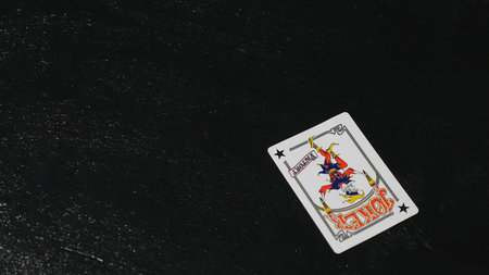 two jokers on the table. black background.
