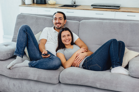Husband and wife sitting on a sofaの写真素材
