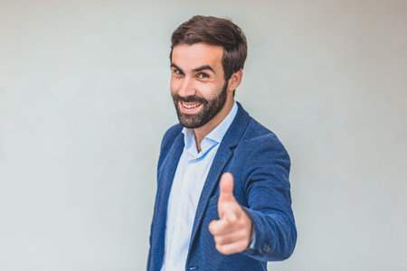 Business partner in a blue jacket. With the look of a serious businessman. Good looks. On a gray...