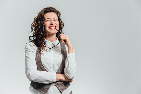 A young man with a white shirt with his hand expressing not a positive attitude. Lift the index finger upの写真素材