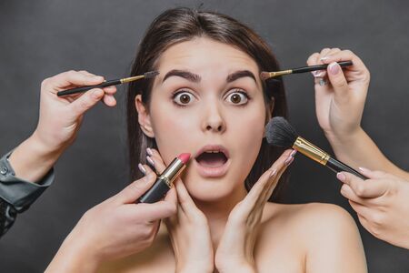 Close up portrait of beauty model girl and make up brushes, lipstick.の写真素材