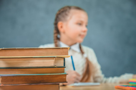 Back to school. Child in the class room on the blurred background.