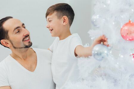 Happy Family Decorating Christmas Tree. Christmas timeの写真素材