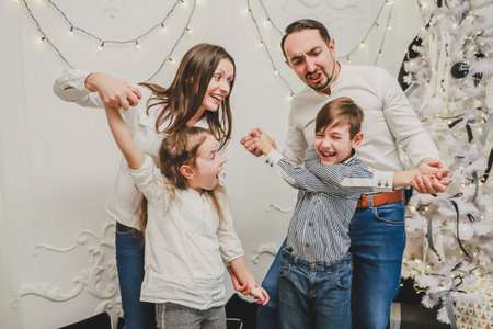 Kids and parents are playing and fooling around on new year evening.の写真素材