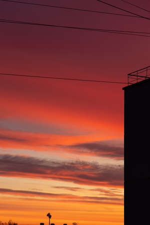 Dawn over the city, storm clouds and black wiresの写真素材