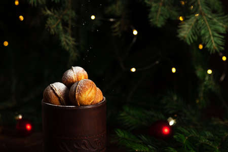 cookies in the form of nuts in a glass. Powdered sugar is poured on top.の写真素材
