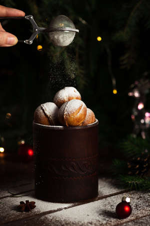 cookies in the form of nuts in a glass. Powdered sugar is poured on top.の写真素材