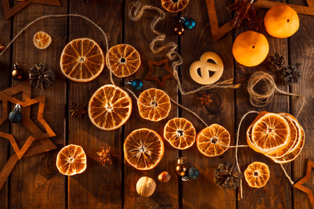 Dried slices of oranges cut into circles lie on a wooden table. New Year's Flatley.の写真素材