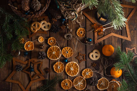 Dried slices of oranges cut into circles lie on a wooden table. New Year's Flatley.の写真素材