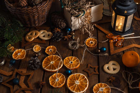Dried slices of oranges cut into circles lie on a wooden table. New Year's Flatley.の写真素材