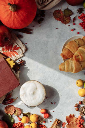 autumn layout. a mug of coffee, apples and spices lie around the place under the textの写真素材