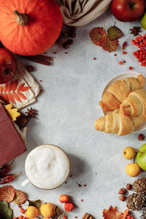 autumn layout. a mug of coffee, apples and spices lie around the place under the textの写真素材