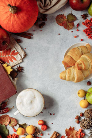 autumn layout. a mug of coffee, apples and spices lie around the place under the text