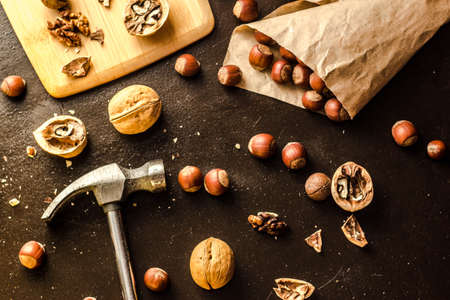 Walnuts and hazelnuts are on the table. Whole and broken nutshells lie on a backgroundの写真素材